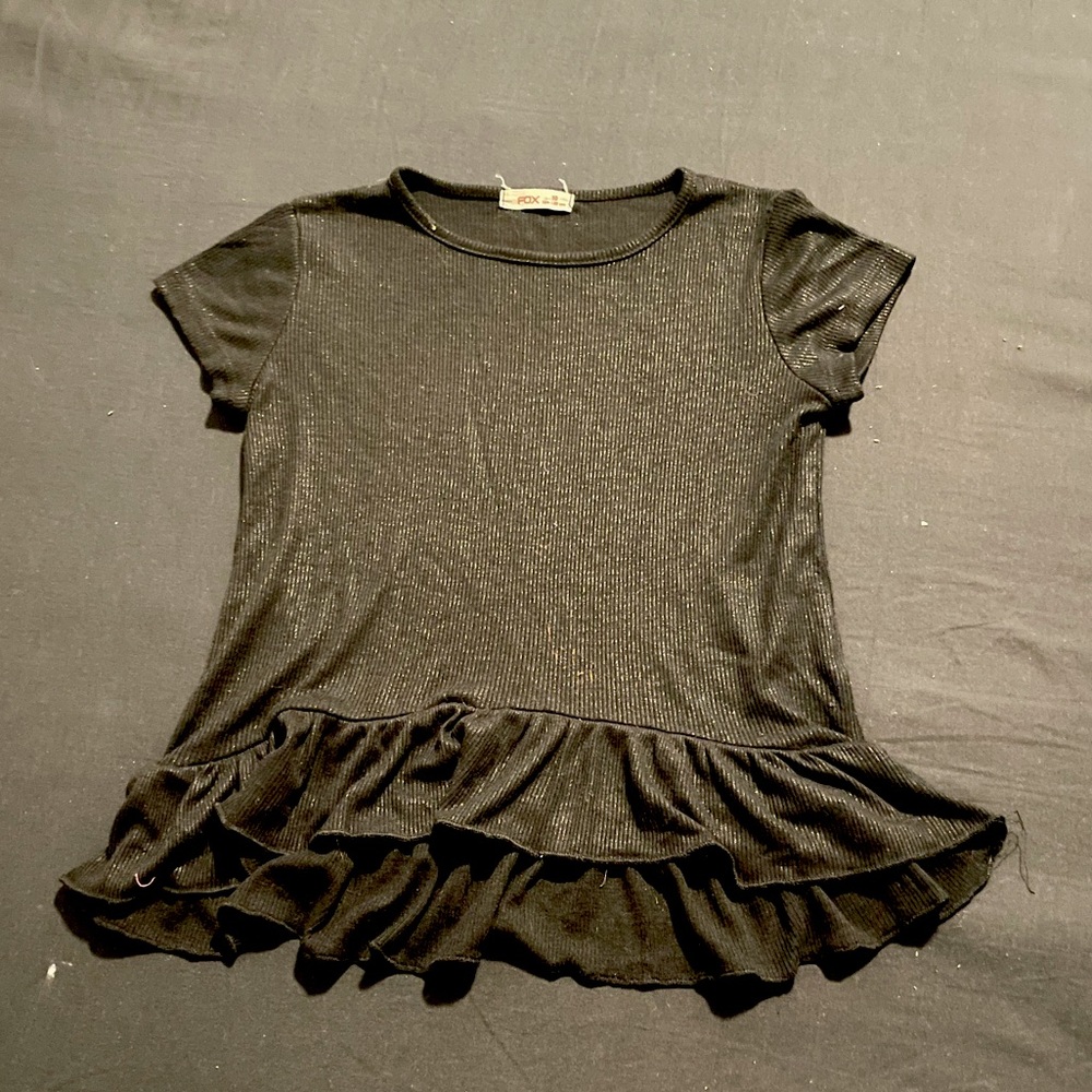 black kids shirt with silver shine and ruffles on bottom